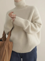 Women's oversized turtleneck sweater in soft fuzzy knit with ribbed cuffs