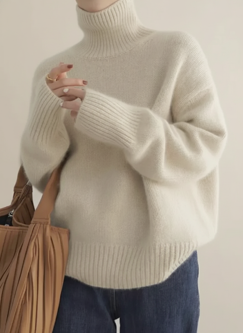 Women's oversized turtleneck sweater in soft fuzzy knit with ribbed cuffs