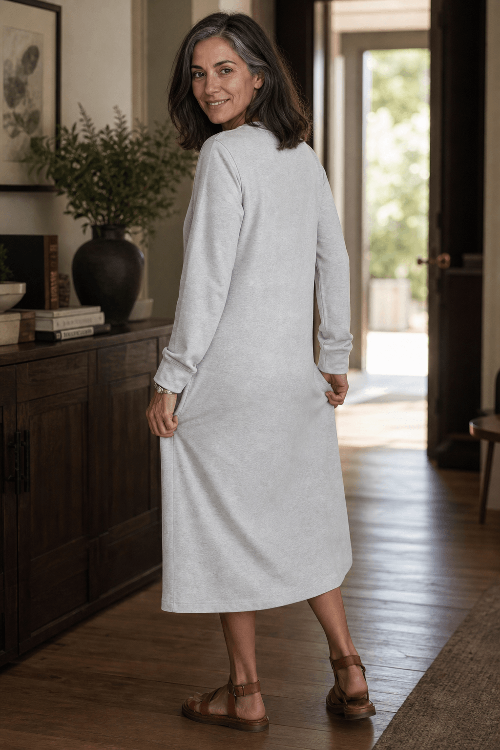 Woman wearing a relaxed A-line V-neck midi sweater dress with long sleeves - view 5