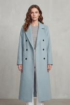 Woman wearing a long black double-breasted coat with notch lapels and six buttons - view 10