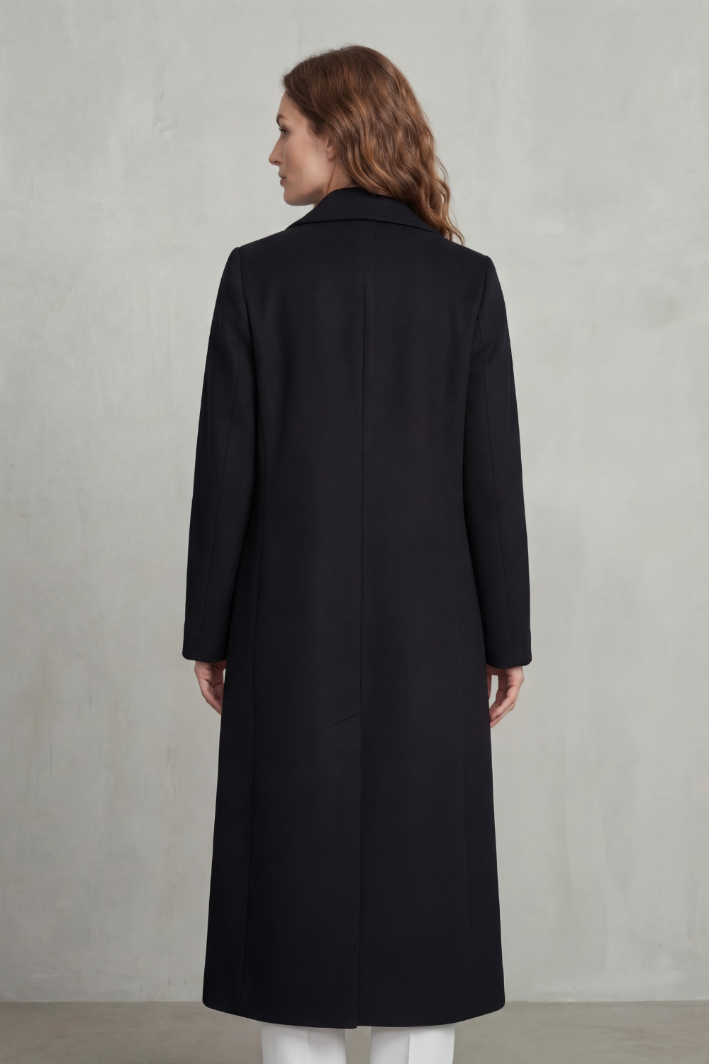 Woman wearing a long black double-breasted coat with notch lapels and six buttons - view 4