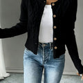 Cropped cable knit button up cardigan with gold-tone buttons and crew neck