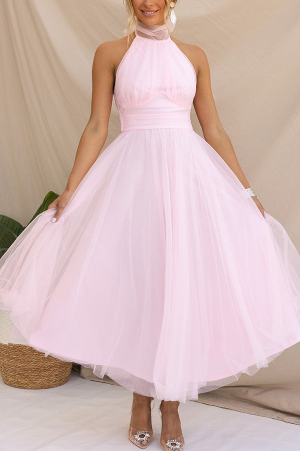 Woman wearing a sleeveless tulle halter midi dress with ruched bodice and full skirt - view 12