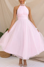 Woman wearing a sleeveless tulle halter midi dress with ruched bodice and full skirt - view 13