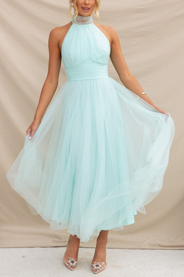 Woman wearing a sleeveless tulle halter midi dress with ruched bodice and full skirt - view 2
