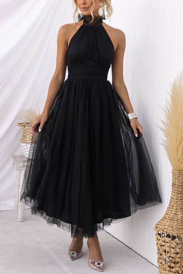 Woman wearing a sleeveless tulle halter midi dress with ruched bodice and full skirt - view 4