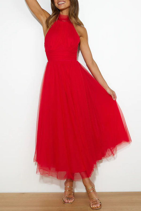 Woman wearing a sleeveless tulle halter midi dress with ruched bodice and full skirt - view 7