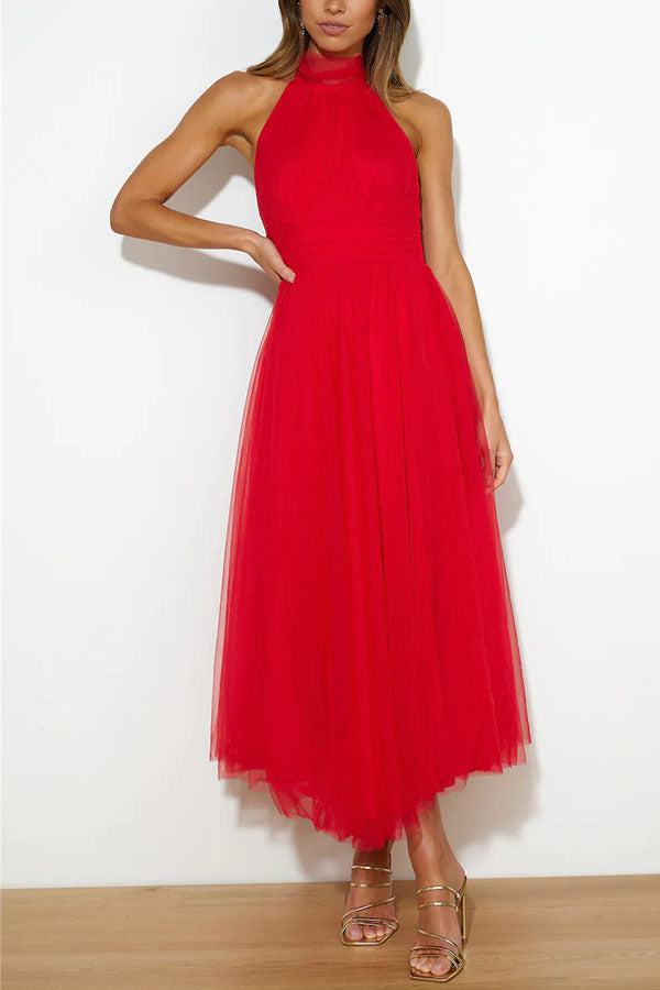 Woman wearing a sleeveless tulle halter midi dress with ruched bodice and full skirt - view 8