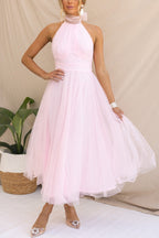 Woman wearing a sleeveless tulle halter midi dress with ruched bodice and full skirt - view 9