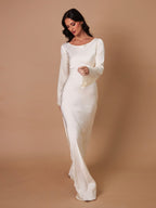 Woman wearing a fitted satin long sleeve maxi dress with bell sleeves and wide scoop neckline - view 13