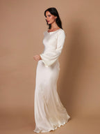 Woman wearing a fitted satin long sleeve maxi dress with bell sleeves and wide scoop neckline - view 15