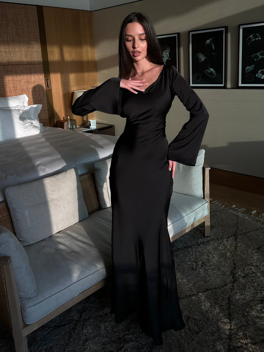 Woman wearing a fitted satin long sleeve maxi dress with bell sleeves and wide scoop neckline - view 17