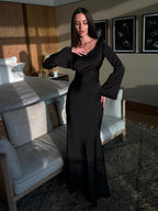 Woman wearing a fitted satin long sleeve maxi dress with bell sleeves and wide scoop neckline - view 17