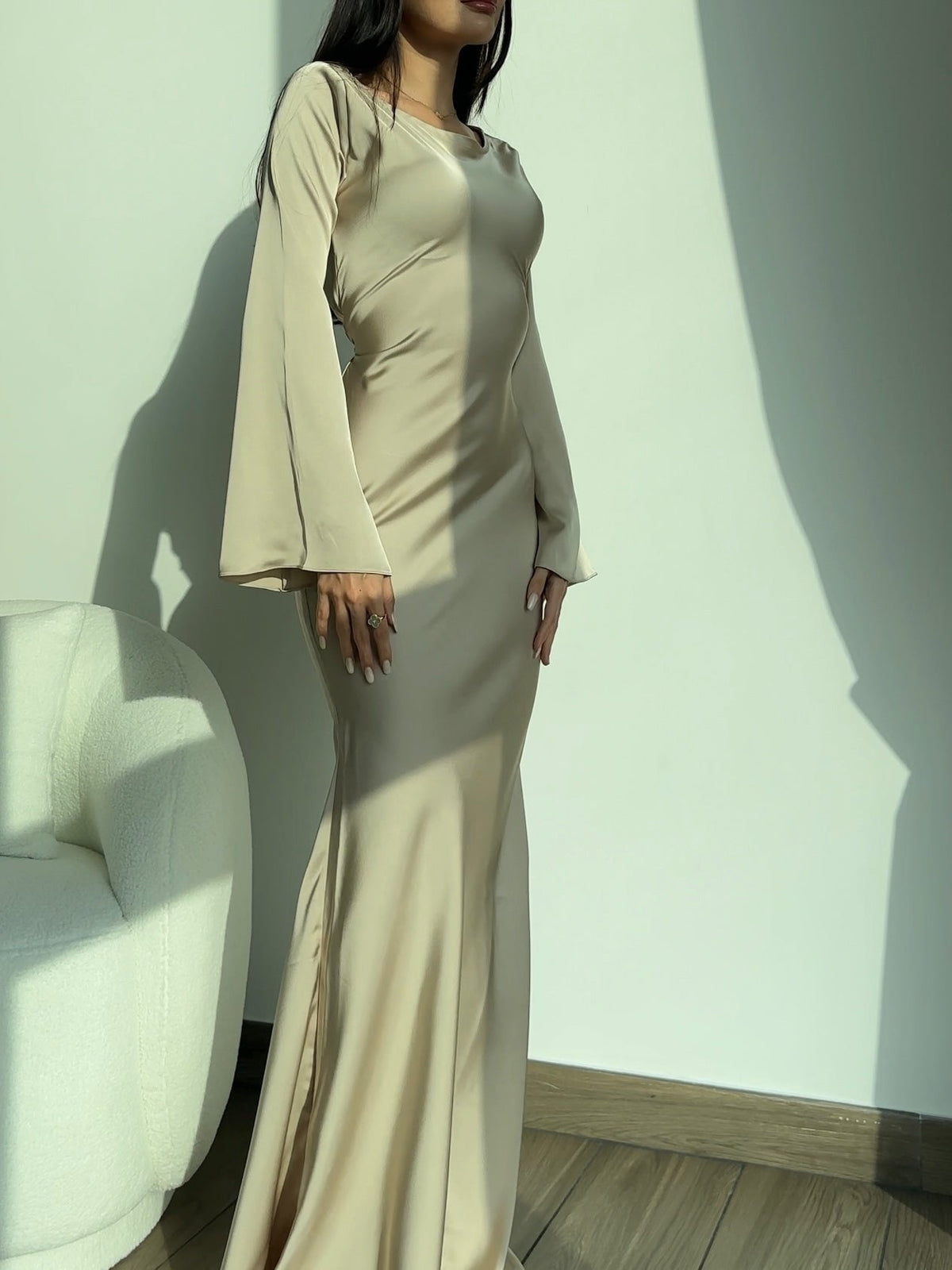 Woman wearing a fitted satin long sleeve maxi dress with bell sleeves and wide scoop neckline - view 4