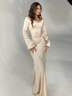 Woman wearing a fitted satin long sleeve maxi dress with bell sleeves and wide scoop neckline - view 6