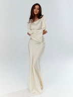 Woman wearing a fitted satin long sleeve maxi dress with bell sleeves and wide scoop neckline - view 8