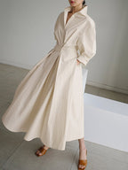 Woman wearing a long sleeve maxi shirt dress with collar, button waist and pleated A-line skirt - view 2