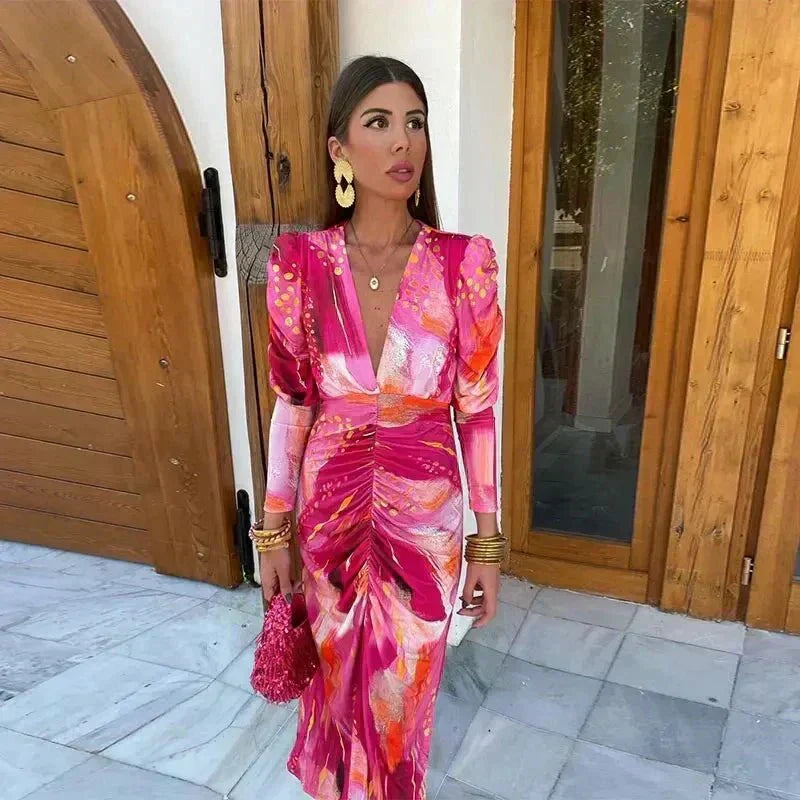 Pink abstract print long sleeve dress with plunging V-neck, puff shoulders and ruched front