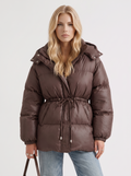Woman in a brown quilted hooded puffer jacket with drawstring waist