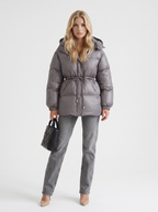 Woman in a brown quilted hooded puffer jacket with drawstring waist - view 14
