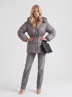Woman in a brown quilted hooded puffer jacket with drawstring waist - view 17