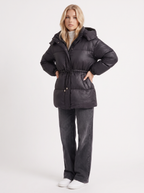 Woman in a brown quilted hooded puffer jacket with drawstring waist - view 21