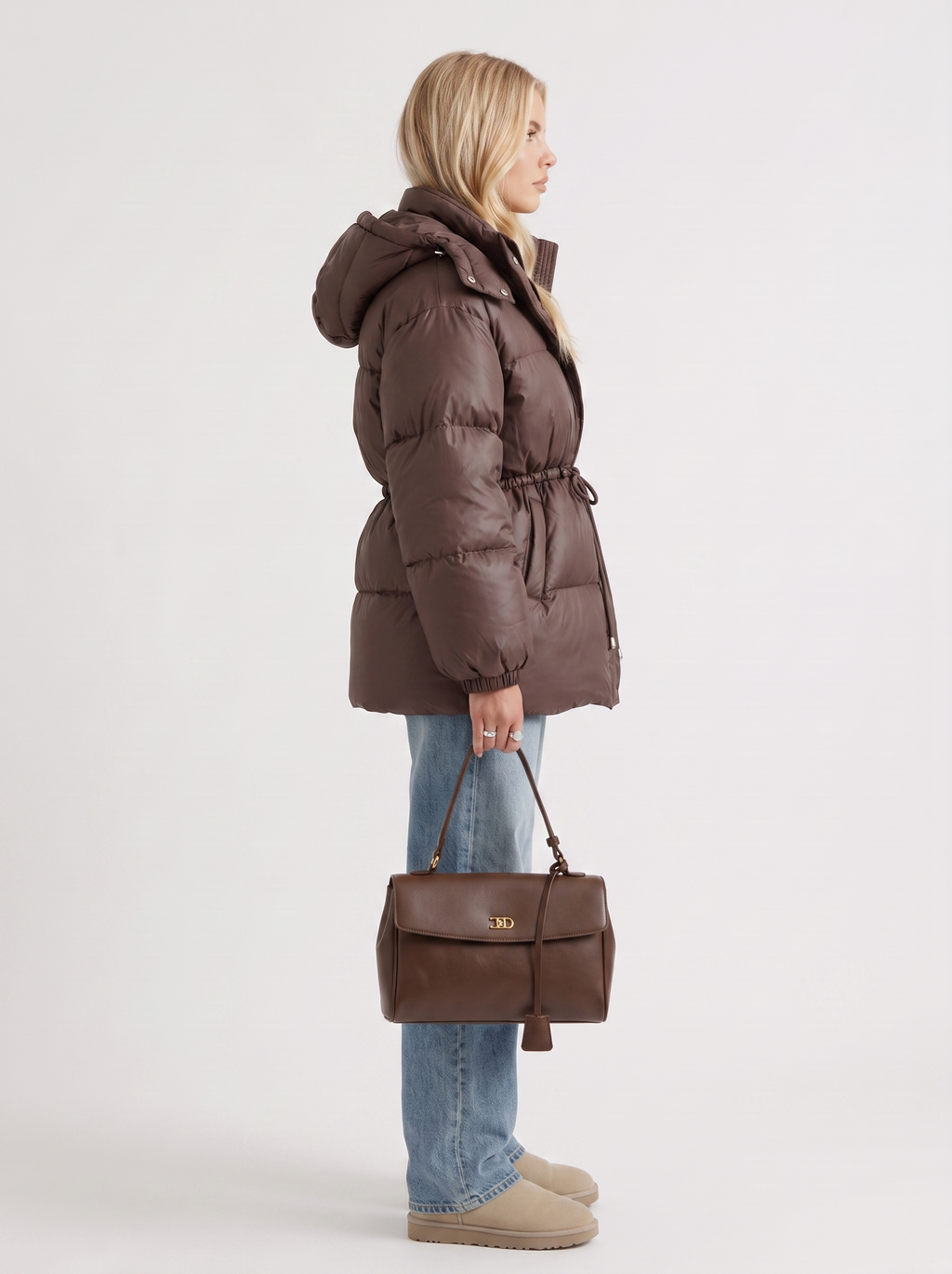 Woman in a brown quilted hooded puffer jacket with drawstring waist - view 4