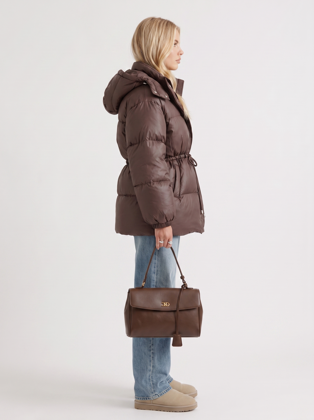 Woman in a brown quilted hooded puffer jacket with drawstring waist - view 4