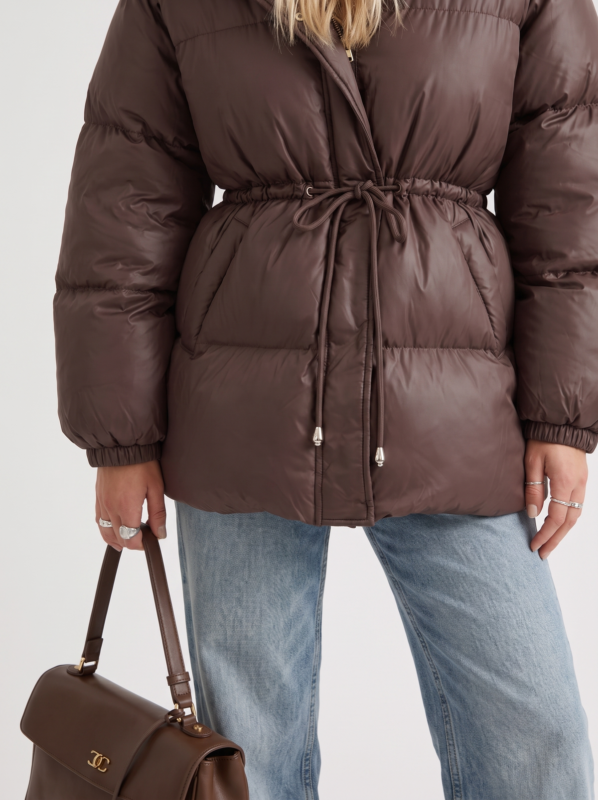 Woman in a brown quilted hooded puffer jacket with drawstring waist - view 6