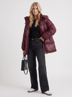 Woman in a brown quilted hooded puffer jacket with drawstring waist - view 9