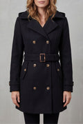 Woman wearing a black hooded double-breasted belted trench coat
