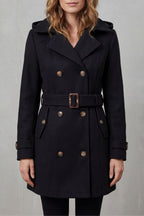 Woman wearing a black hooded double-breasted belted trench coat