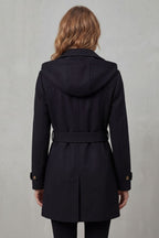 Woman wearing a black hooded double-breasted belted trench coat - view 4