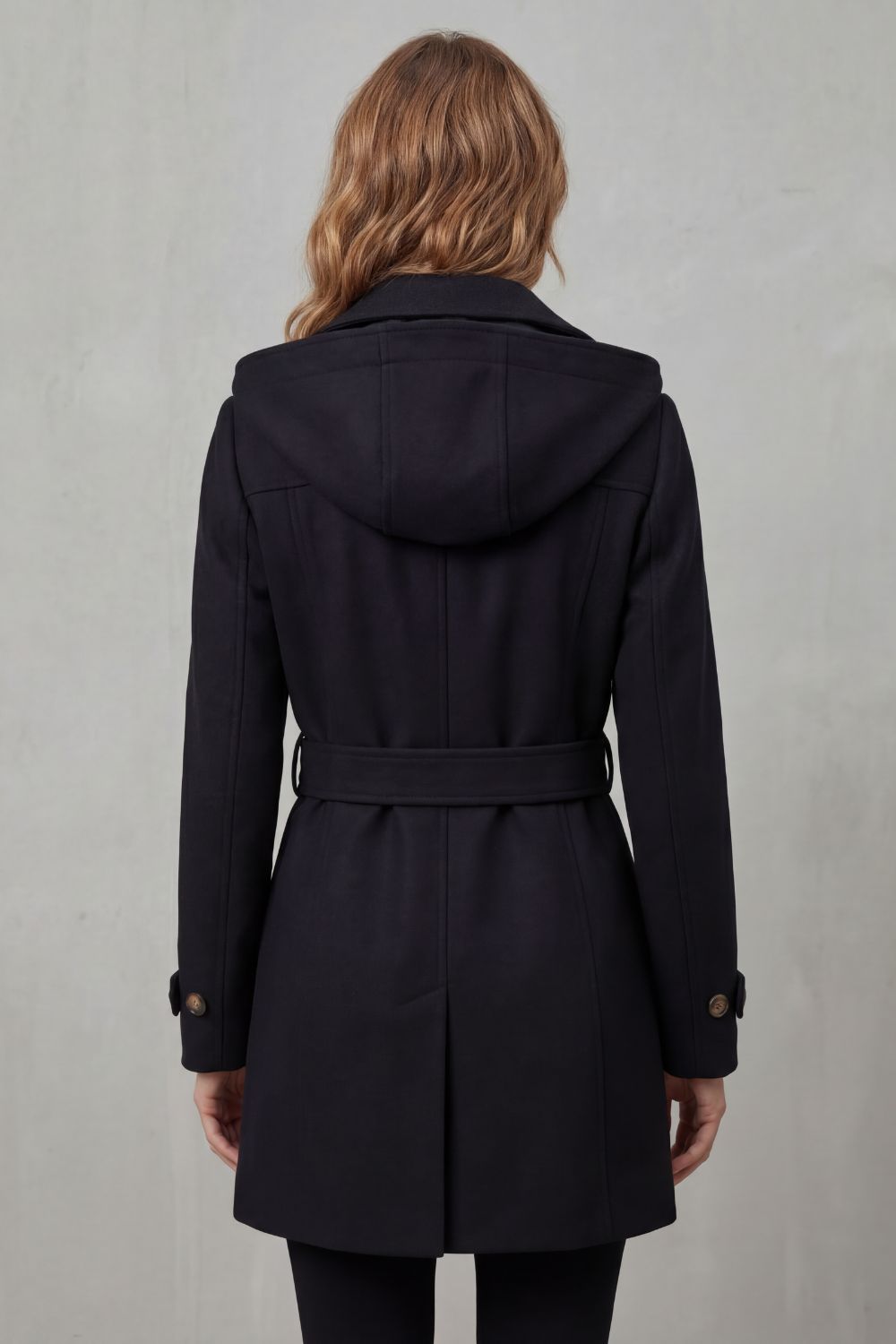Woman wearing a black hooded double-breasted belted trench coat - view 4