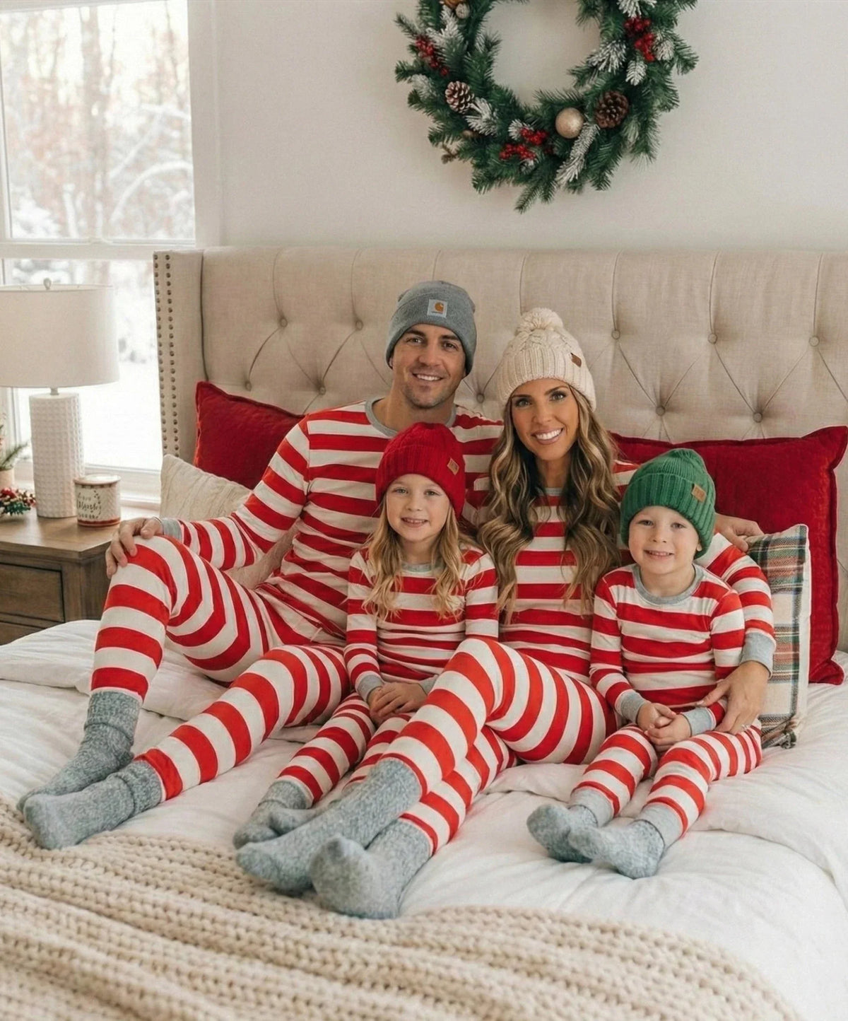 Family in matching red and white striped Christmas pajamas with gray cuffs - view 17
