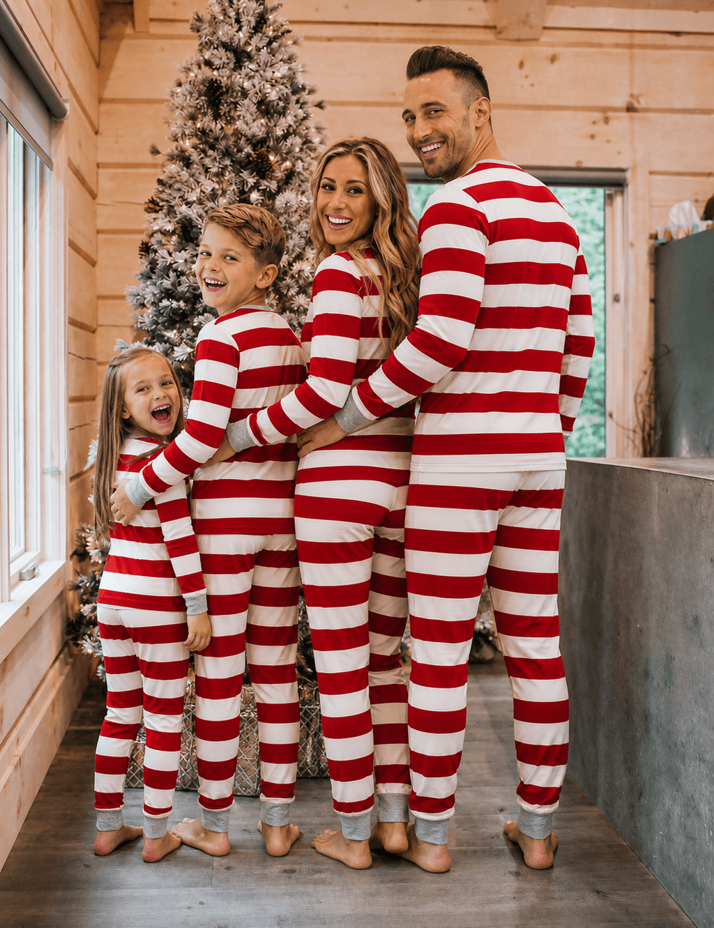 Family in matching red and white striped Christmas pajamas with gray cuffs - view 2
