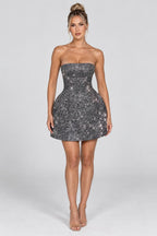 Strapless glitter mini dress with oversized back bow and structured A-line skirt