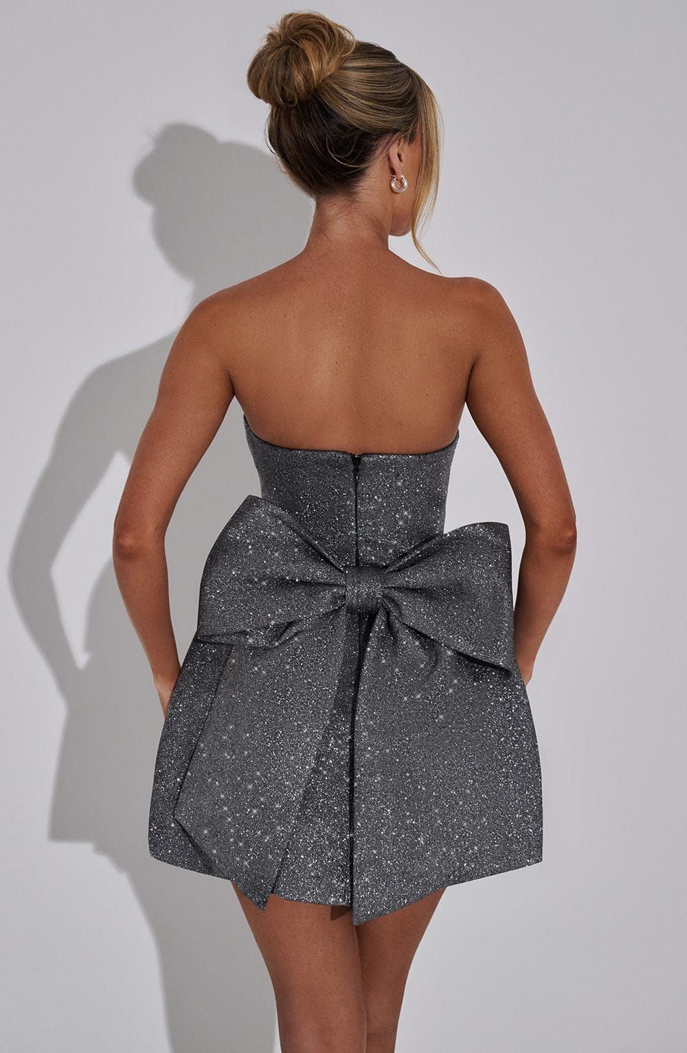 Strapless glitter mini dress with oversized back bow and structured A-line skirt - view 15