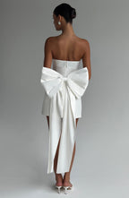 Woman wearing a white strapless A-line mini dress with an oversized back bow and long trailing tails - view 3