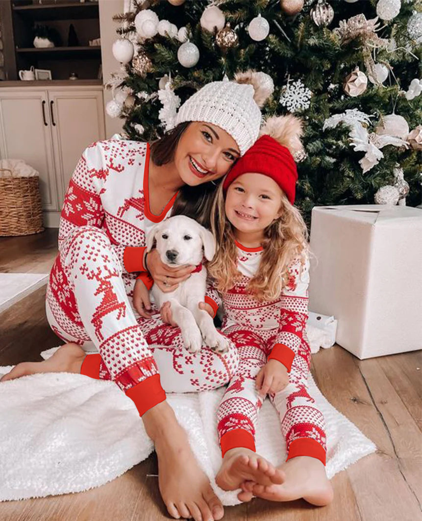 Family wearing matching red and white reindeer and snowflake print Christmas pajamas - view 10