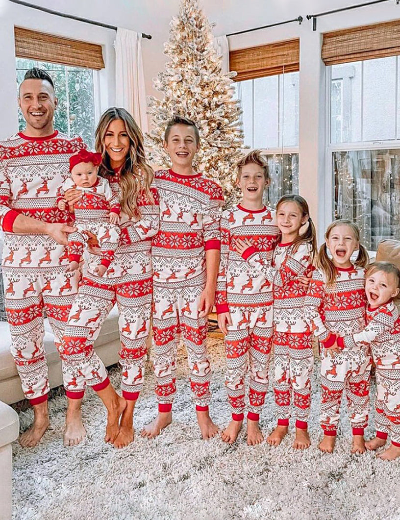 Family wearing matching red and white reindeer and snowflake print Christmas pajamas - view 11