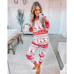 Family wearing matching red and white reindeer and snowflake print Christmas pajamas - view 4