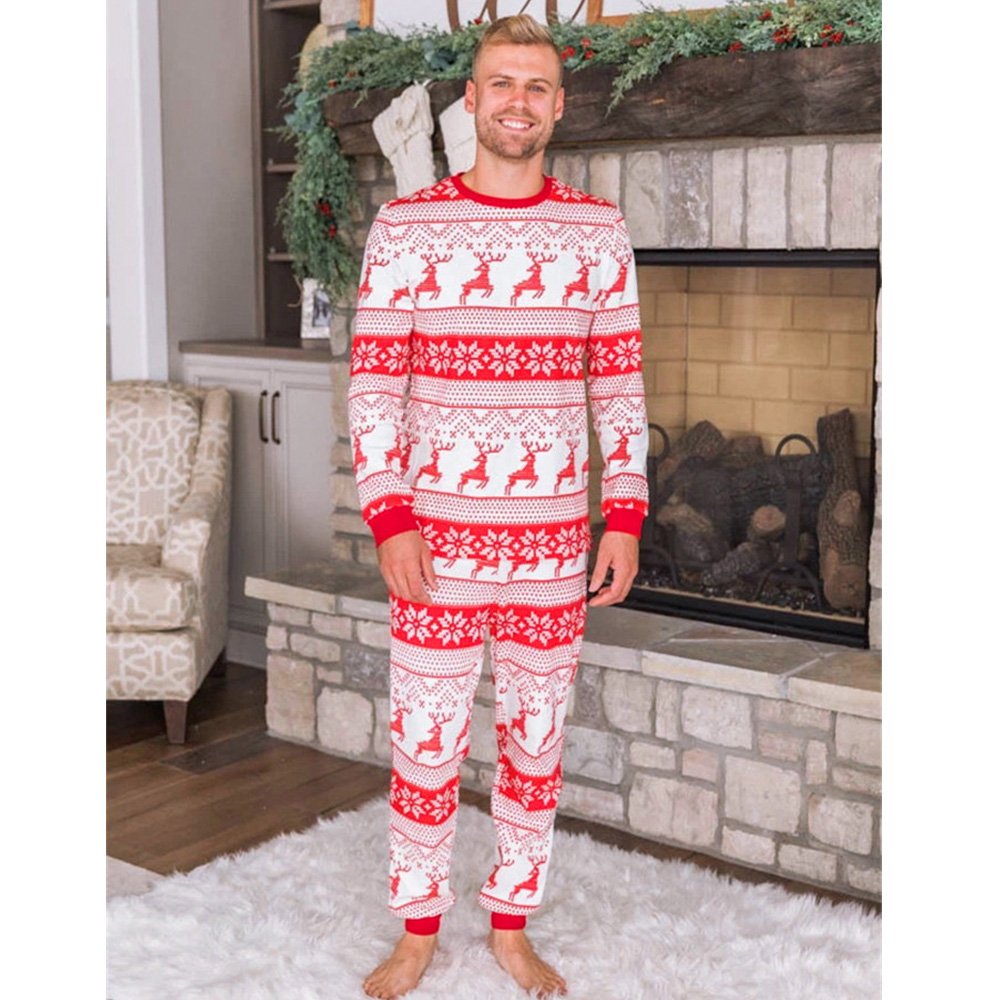 Family wearing matching red and white reindeer and snowflake print Christmas pajamas - view 5