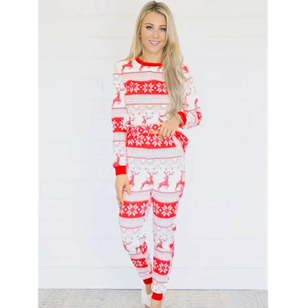 Family wearing matching red and white reindeer and snowflake print Christmas pajamas - view 9