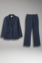 Navy tailored two piece set with single-button peak lapel blazer and high-rise straight leg pants