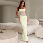 Woman wearing a fitted lace panel maxi dress with tie straps and straight neckline