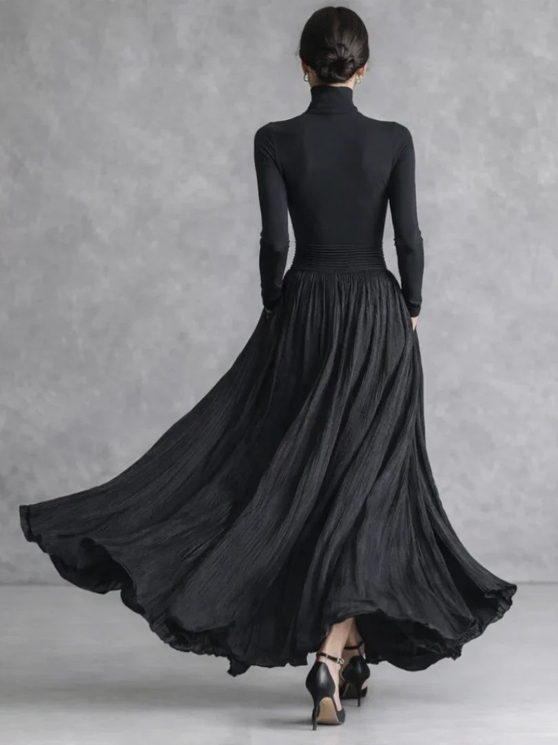 Woman in a black pleated turtleneck maxi dress with long sleeves and front slit - view 4