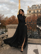 Woman in a black pleated turtleneck maxi dress with long sleeves and front slit - view 5