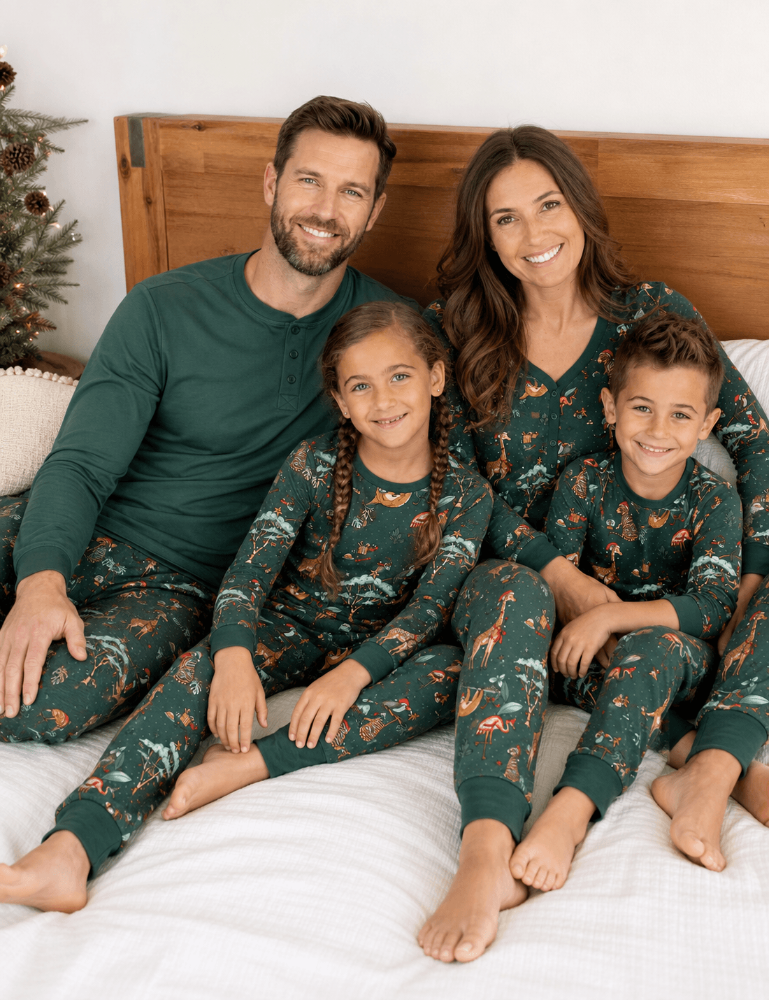Family wearing matching green safari animal print Christmas pajamas