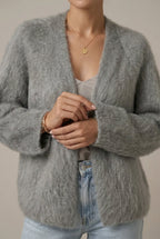 Woman wearing a fluffy open front cardigan in brushed knit over a cami and jeans - view 2
